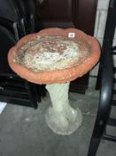 A concrete bird bath