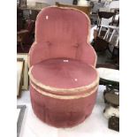 A pink upholstered bedroom chair