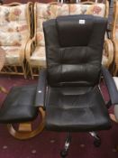 A brown leather effect executive armchair & footstool