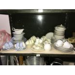 A shelf of 3 part tea/dinner sets