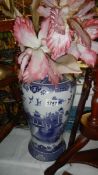 A blue and white willow pattern vase.