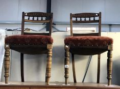 A pair of dining chairs with deep upholstered seats
