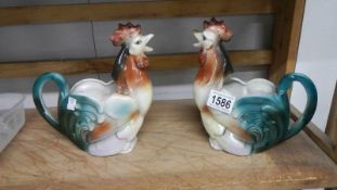 A pair of cockerel shaped jugs.