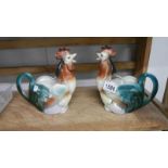 A pair of cockerel shaped jugs.