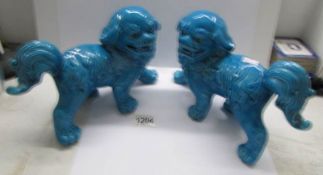 A pair of Chinese blue pottery 'Dogs of Foo'.