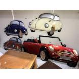 4 pressed steel wall hangings of cars,