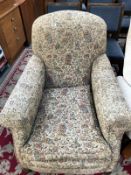 A 1930's style armchair with tapestry style fabric upholstery