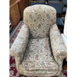 A 1930's style armchair with tapestry style fabric upholstery