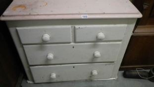 An old painted 2 over 2 chest of drawers.