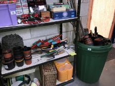 A shelf of gardening tools, pots,