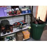 A shelf of gardening tools, pots,