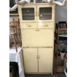 A cream coloured retro kitchen cabinet