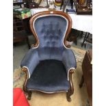 A cabriole leg arm chair in blue.