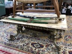A marble top coffee table with brass frame