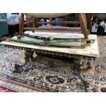 A marble top coffee table with brass frame