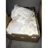A box of old baby clothes & other fabrics/linen
