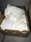 A box of old baby clothes & other fabrics/linen