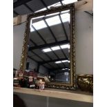 An ornate gilt framed oblong mirror