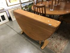 An Ercol drop leaf dining table.