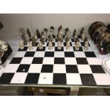 A black & white tiled chess board with Dungeon & Dragon style figure chess pieces