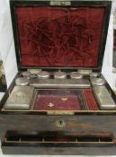 A late Victorian or Early Edwardian vanity box containing glass bottles with white metal lids.