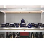 A deep blue & white porcelain tea set with gilded flower decoration, includes teapot,