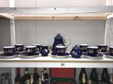 A deep blue & white porcelain tea set with gilded flower decoration, includes teapot,