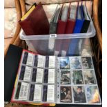 A collection of 7 folders of collectors trading cards including adult, bond,