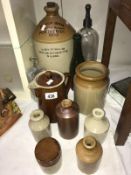 A collection of vintage bottles and earthen jars,