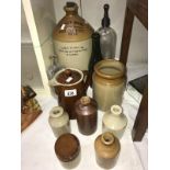 A collection of vintage bottles and earthen jars,