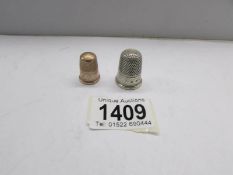 A gold thimble and a silver thimble.