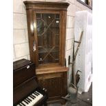 An astragal glazed oak corner cupboard