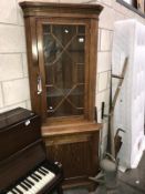 An astragal glazed oak corner cupboard