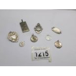 2 silver watch fobs, 4 silver St. Christopher's and 2 other silver items.