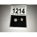 A pair of white gold square shaped diamond earrings.