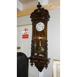 A mahogany single weight Vienna wall clock.