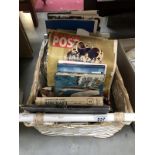 A wicker basket full of various books (many on aircraft)