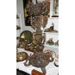 A heavily carved wood stand carved with birds, snakes, grapes etc.