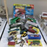 A box of diecast and plastic model vehicles including tractors.