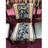 A fully upholstered dining chair with floral pattern