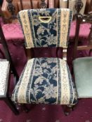 A fully upholstered dining chair with floral pattern