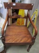 A Victorian mahogany elbow chair.