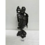 A carved wood Chinese figure.