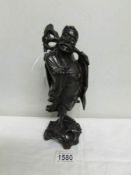 A carved wood Chinese figure.