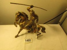 A heavy brass horse surmounted warrior.