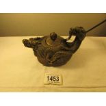 A Chinese bronze dragon teapot, signed.