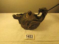 A Chinese bronze dragon teapot, signed.