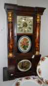 An inlaid American wall clock with sloping front and painted flowers.
