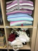 A quantity of ladies cardigans (some new) and a shelf of scarves, gloves etc.