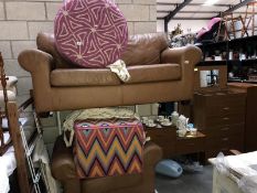 A tan coloured leather effect 2 seat sofa & matching armchair